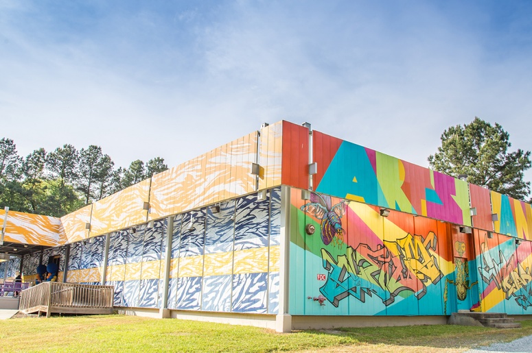 Photo of the outside of the Arts Annex showing colorful murals on the building