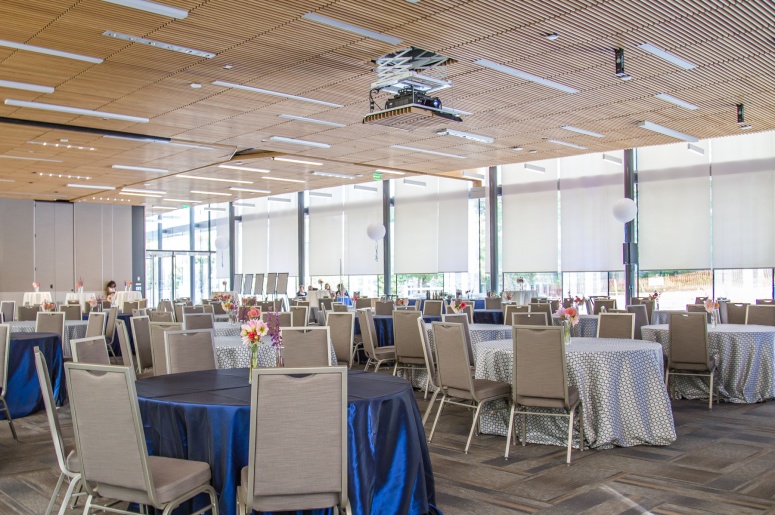 Photo of Penn Pavilion Room showing round tables, chairs, and windows.
